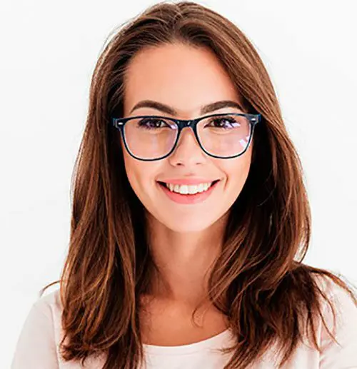 A woman with glasses smiling for the camera.